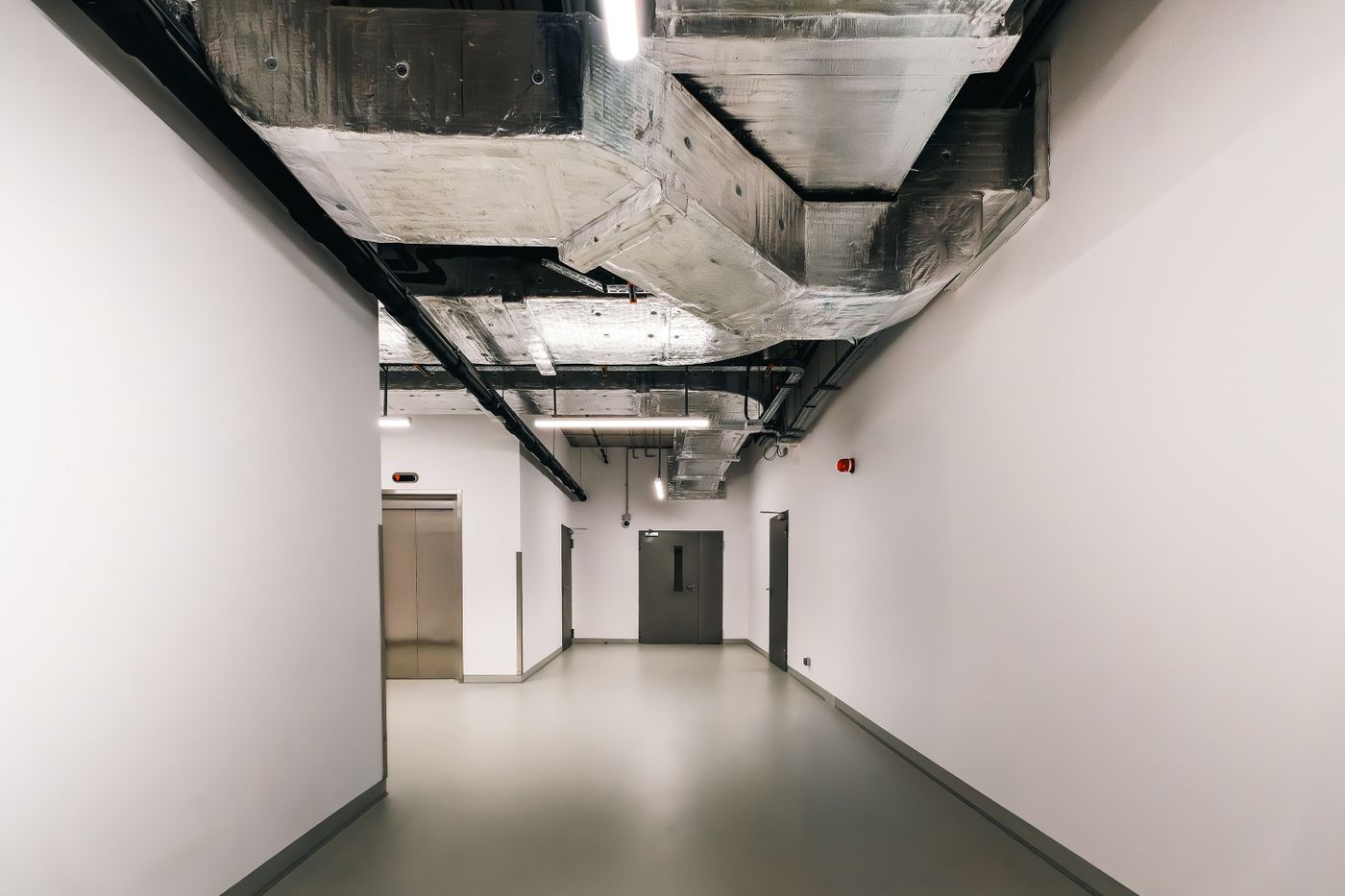 Exposed residential HVAC ductwork running along an interior ceiling